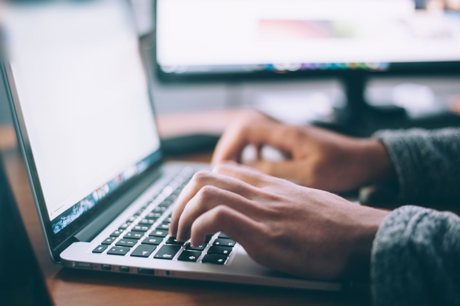Employee Working Hard on his Laptop writing Alt-Text.